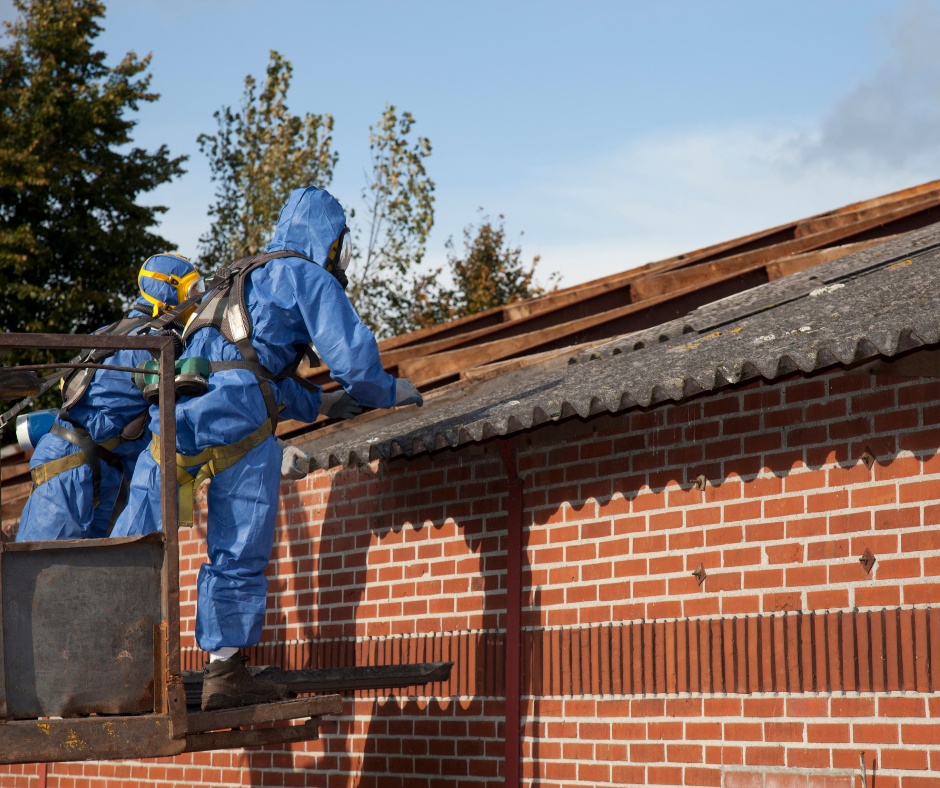 operators in blue overalls working on the asbestos treatment of a canopy