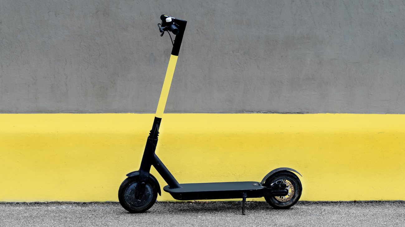 yellow and black scooter on a yellow and grey background