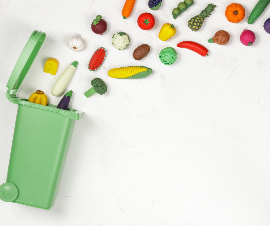 green bin with food placed in it to symbolise food waste